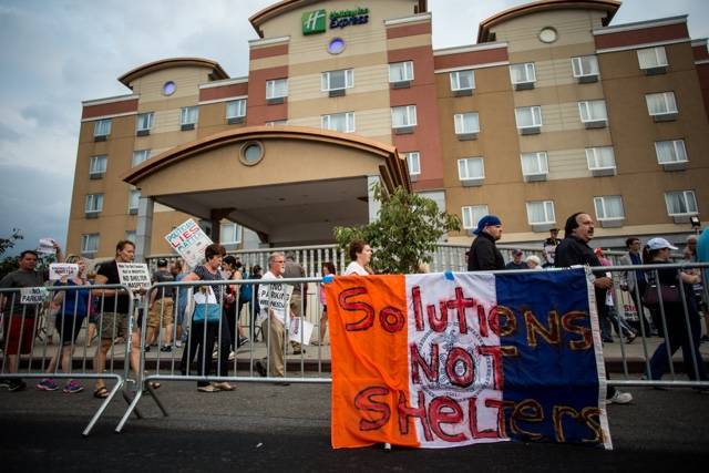 Maspeth, Queens residents protested plans to convert a Holiday Inn Express into a shelter. When the plan was scrapped last year, DHS rented out some rooms for homeless men.
